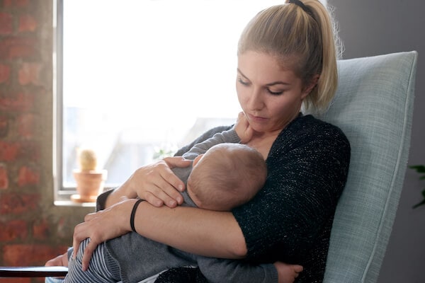 woman breastfeeding her young baby