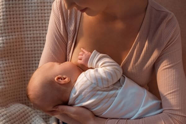 Woman breastfeeing her young baby