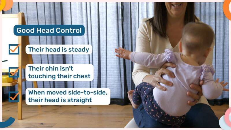 Emma Hubbard holding a baby on her lap with hands supporting the baby's sides. Gently tilting the baby to one side to test head control